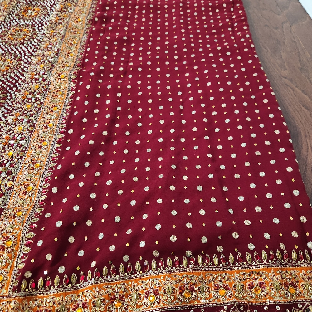 Heavy Maroon And Gold Embellished Georgette Saree With XS Blouse.